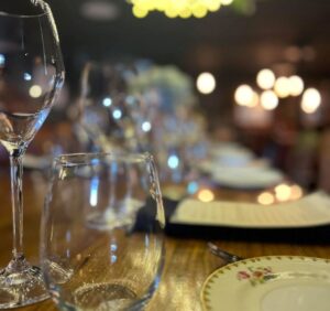 Finely set dinner table with stemware and vintage plates