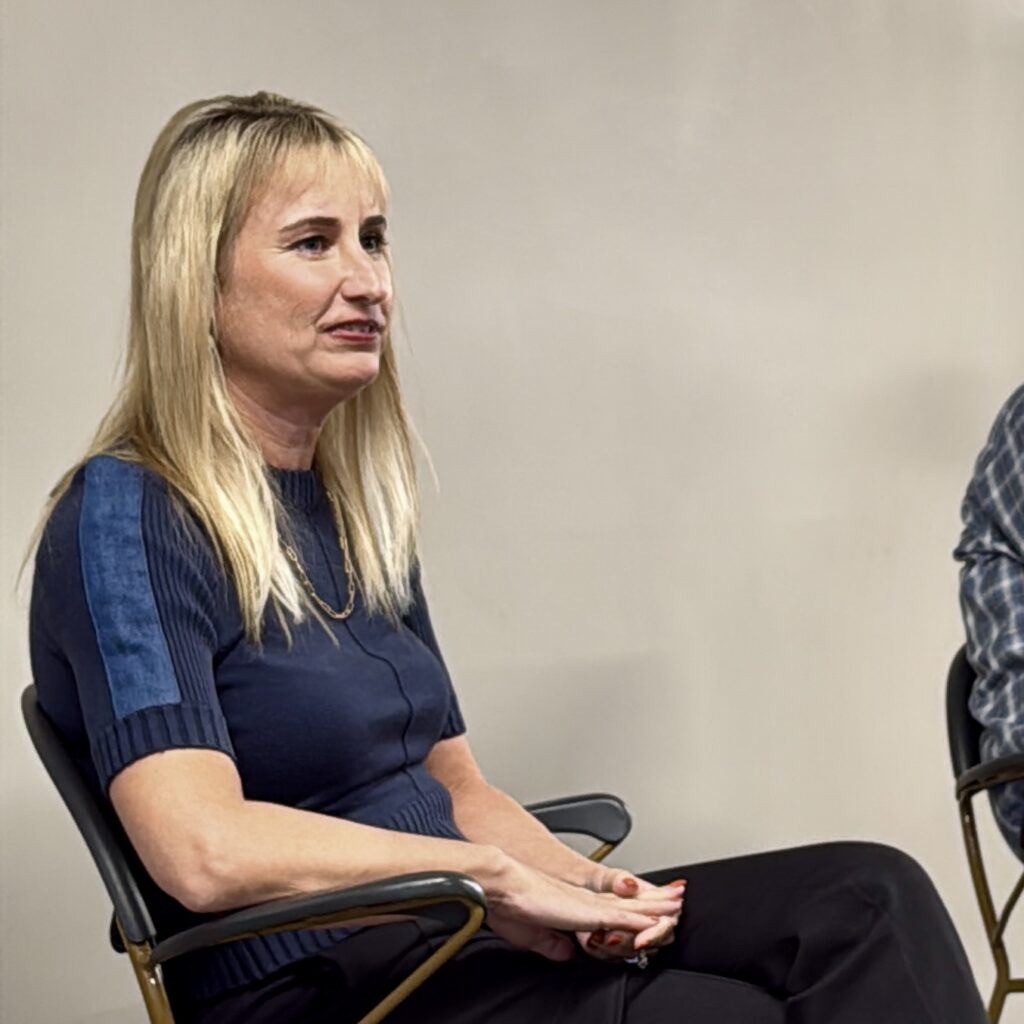 Blonde woman speaking at college