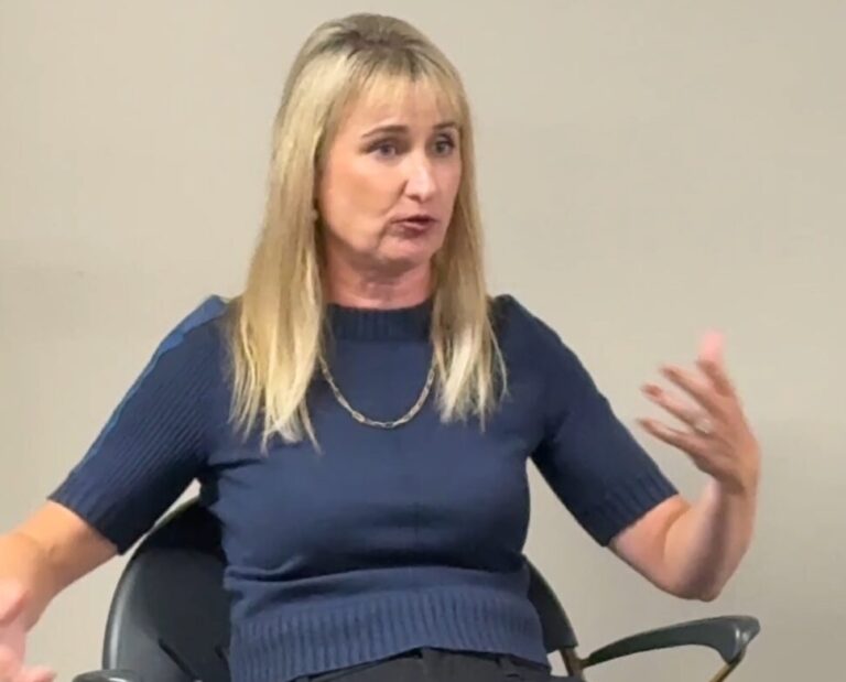 Blonde woman speaking at college event