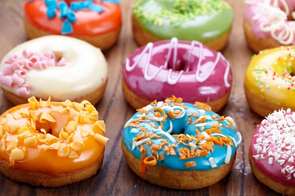 Plate of colorful frosted donuts