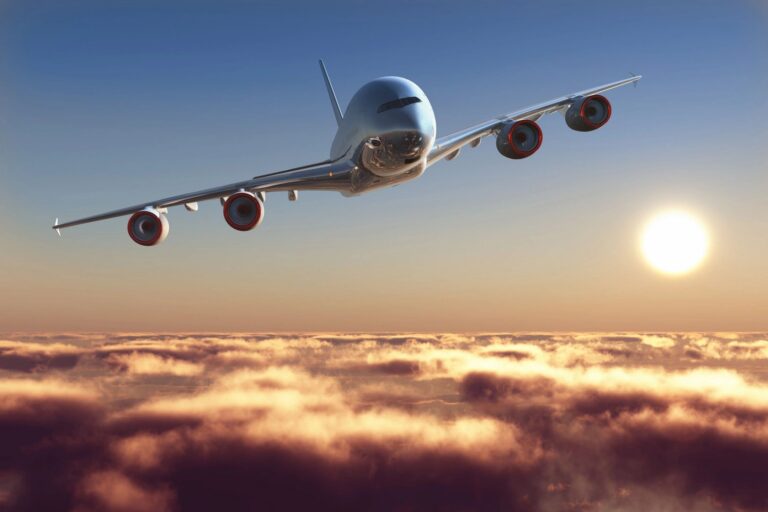 Jet Plane flying over clouds with sun in background
